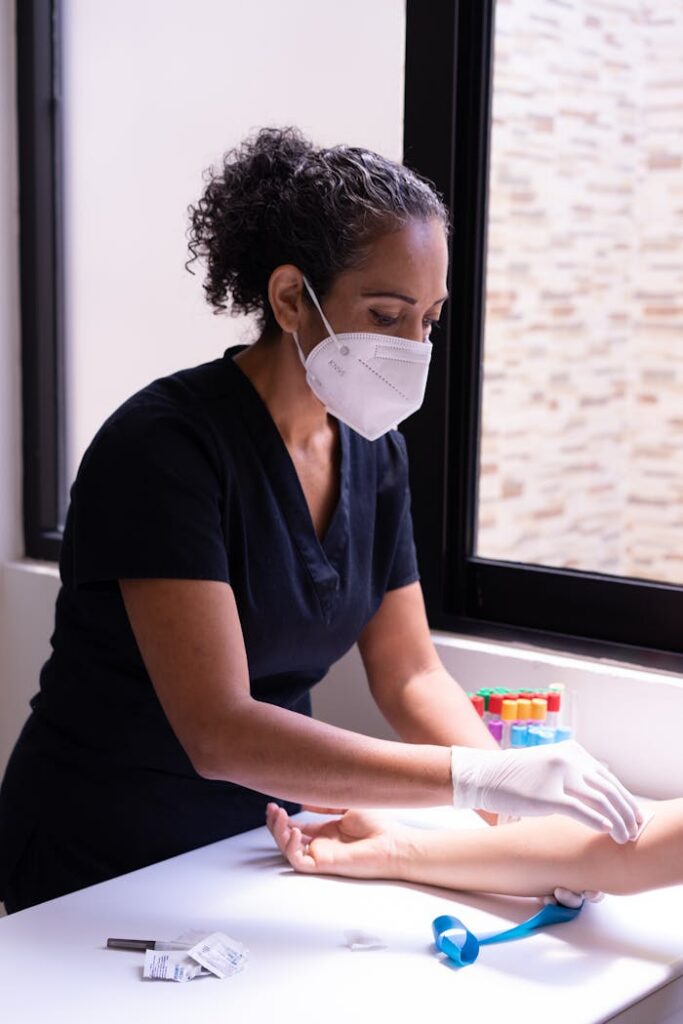 Professional nurse prepares a patient for a blood test in a medical clinic.