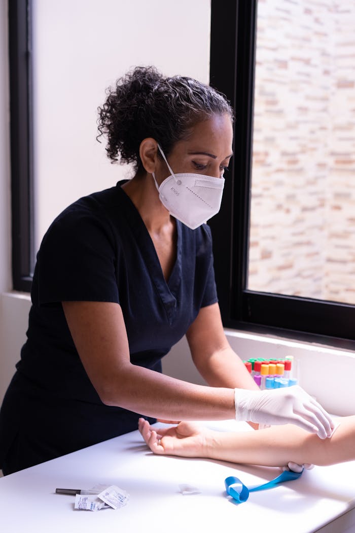 Professional nurse prepares a patient for a blood test in a medical clinic.