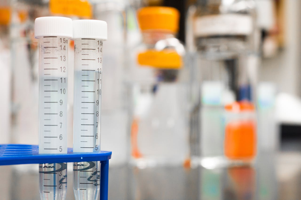 our-story-01 Two clear test tubes in a laboratory, essential for scientific research.